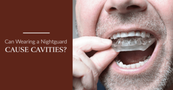 Can wearing a night guard case cavities? Man putting in a clear nightguard